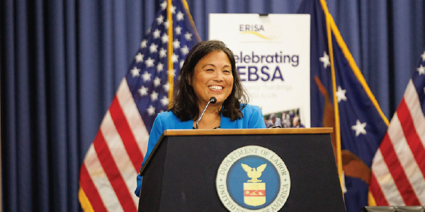 Acting Secretary Julie Su speaking at a podium