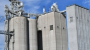 Grain elevator towering against a blue sky. 