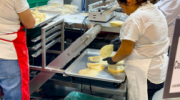 A view of workers making flour tortillas.