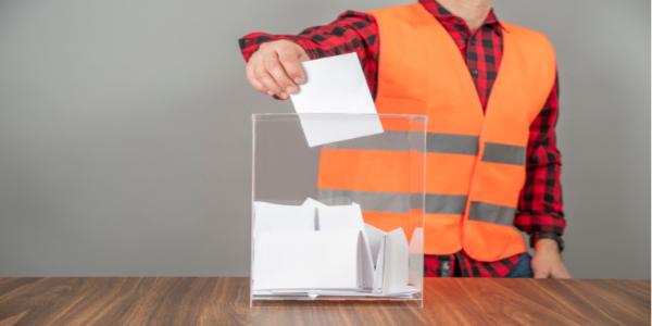 A union voter casting a ballot in a ballot box on union election day.