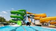 Outdoor water park. Multi-colored slides and pools.