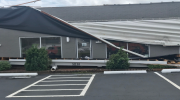 A building’s roof is partially collapsed by hurricane-driven winds.