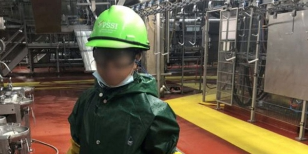 A child working in a slaughterhouse.