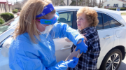 Nurse Practitioner Leslie Stefanowicz administers an injection to a patient during the Coronavirus Pandemic. 