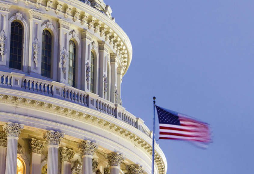 US flag in front of US Capitol.