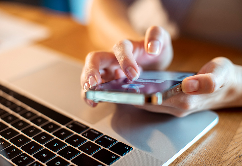 Person viewing a Linked in profile on their cell phone.