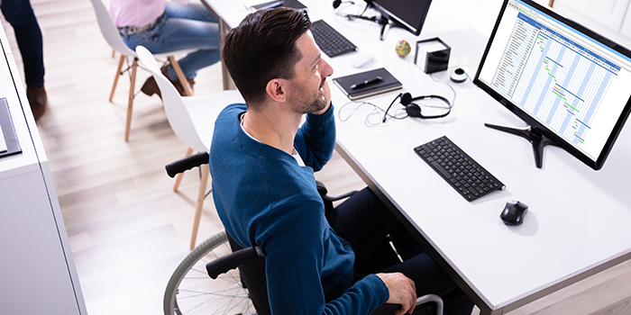 Man in wheelchair taking online course.