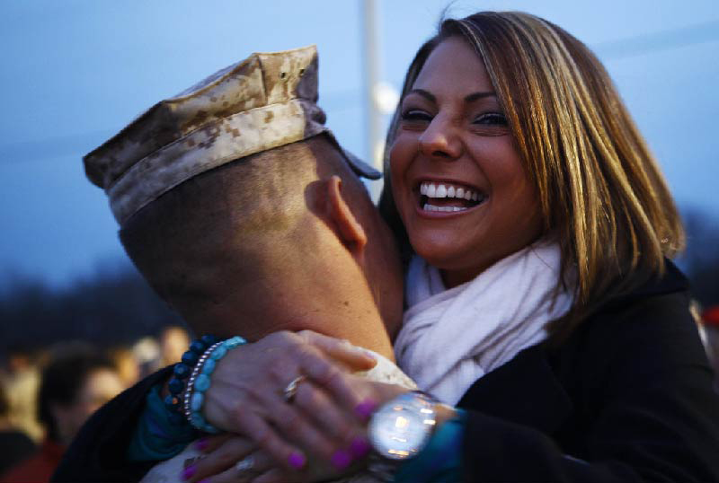 serviceman and a woman hugging