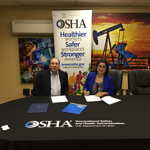 Elizabeth Linda Routh, area director of OSHA’s Lubbock Area Office and Phil Young, executive director for the West Texas Safety Training Center sign a three-year alliance renewal agreement at the Midland training center.