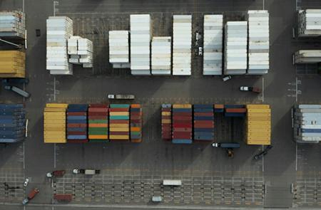 A bird’s eye view of colorful shipping containers. Photo by Tyler Casey for Unsplash.