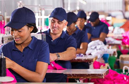 smiling factory workers sewing