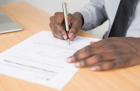 Hands singing a document  